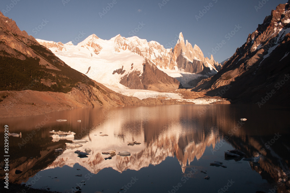 Monte Fitz Roy or Mount Fitzroy and Laguna de Los Tres with snow capped peaks reflected in the water in the lake at sunset. Parque Nacional Los Glaciares, Patagonia, South America