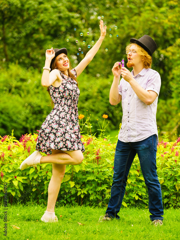 Fototapeta premium Couple blowing bubbles outdoor
