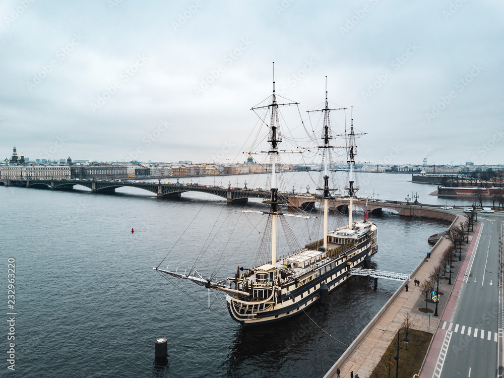Aerial; drone view of cityscape, ship restaurant on the reconstructed linear three-deck frigate of the XVIII century; Troitsky bridge over the Neva river and Petropavlovskaya fortress background