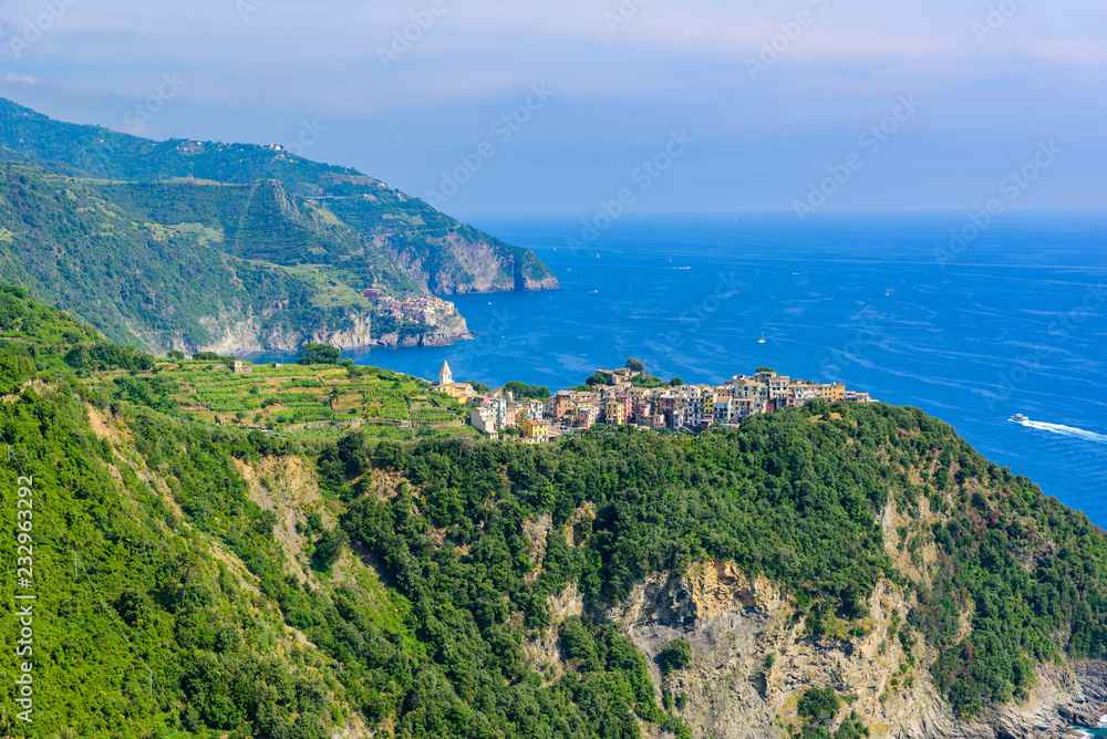 Corniglia - Village of Cinque Terre National Park at Coast of Italy. In the background you can see Manarola. Province of La Spezia, Liguria, in the north of Italy - Travel destination in Europe.