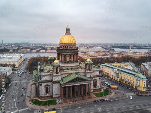Aerial; autumn cloudscape over the famous Isaak Cathedral in the cultural capital of Russia; bright golden dome in the fog; royal time historical part of Sain Petersburg background; a lot of tourists