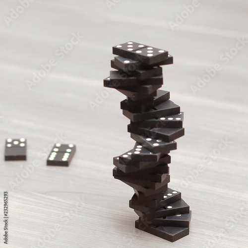 close up. tower of dominoes on a wooden table.photo with copy space