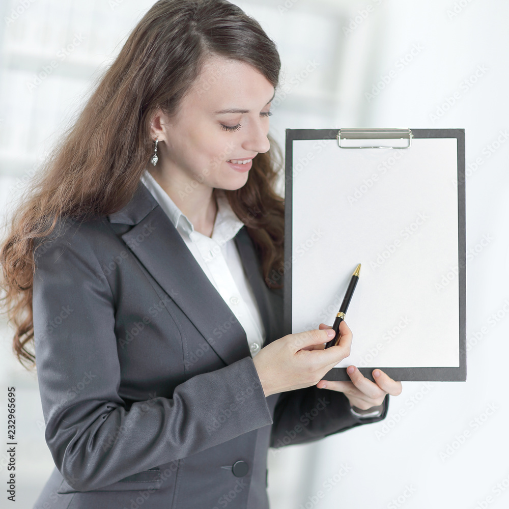 modern business woman pointing at blank sheet. modern business woman pointing at blank sheet.