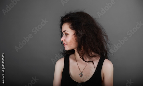 Portrait of a girl on a dark background in the studio