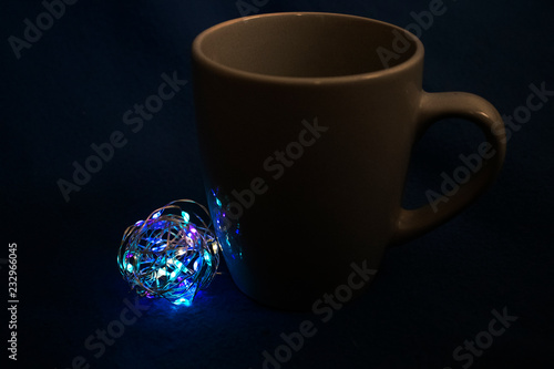 Cup with lighting ball at dark background photo