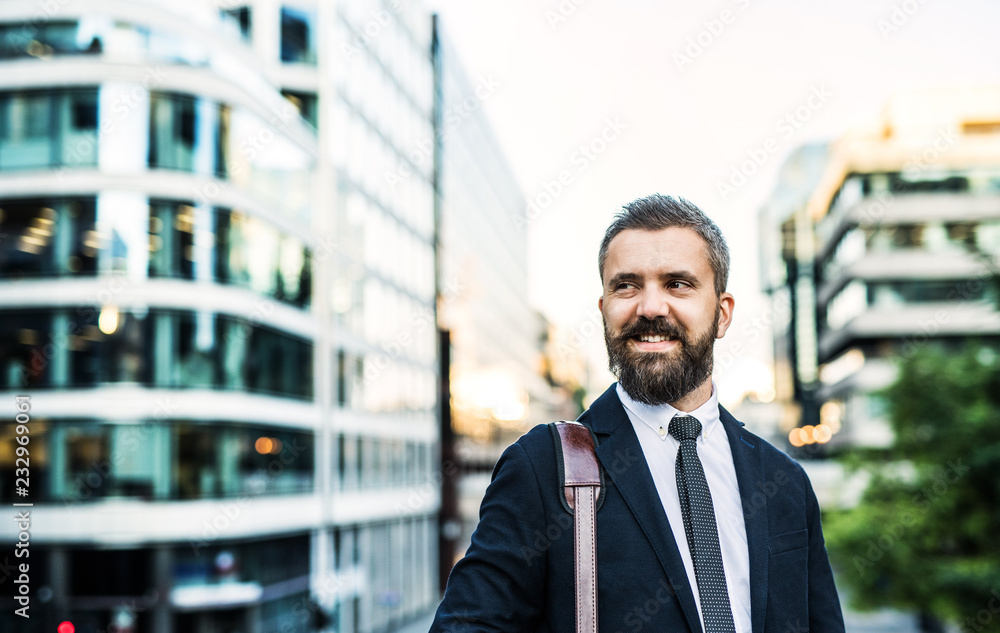 Hipster businessman standing on the street in the city. Copy space. Hipster businessman standing on the street in the city. Copy space.
