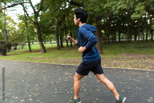 Healthy young asian man jogging at the park