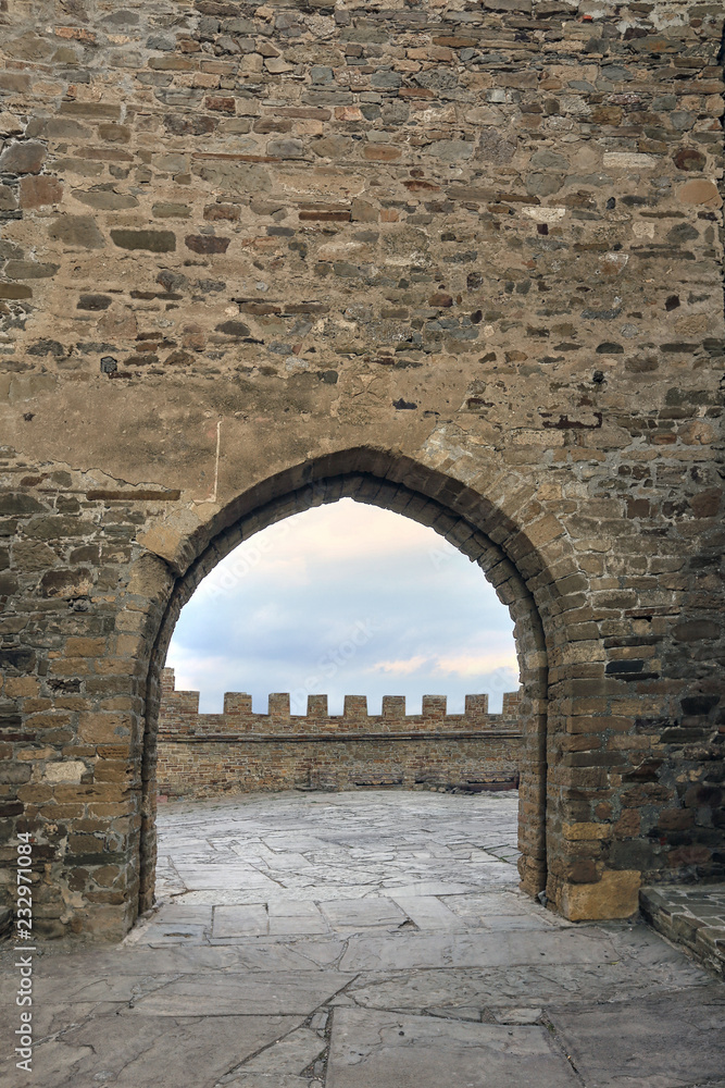 arch in the stone wall of the castle