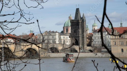 Prague, torurist ships navigation on Vltava river at Charles bridge background. photo