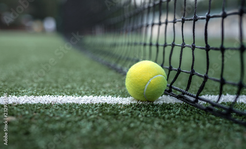 Yellow tennis ball at the net