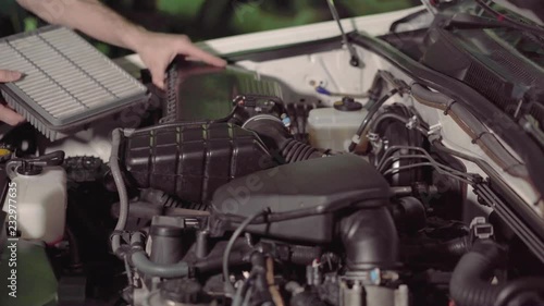 car mechanic checking the engine oil and air filter inspection in a garage or repair shop conducts inspection.4k,30fps.