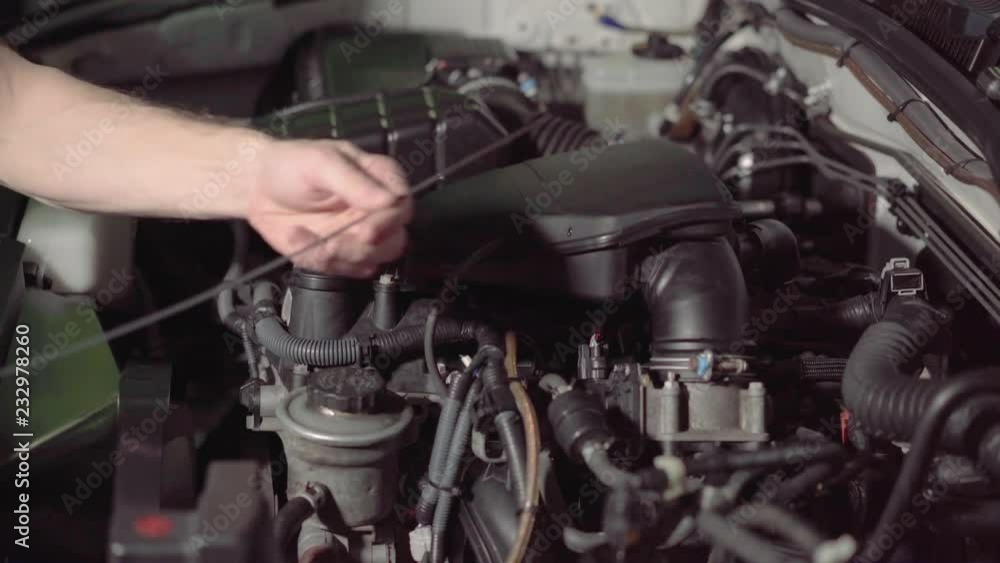 car mechanic checking the engine oil and air filter inspection in a garage or repair shop conducts inspection.4k,30fps. car mechanic checking the engine oil and air filter inspection in a garage or repair shop conducts inspection.4k,30fps.