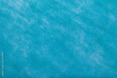 Light blue background of felt fabric. Texture of woolen textile