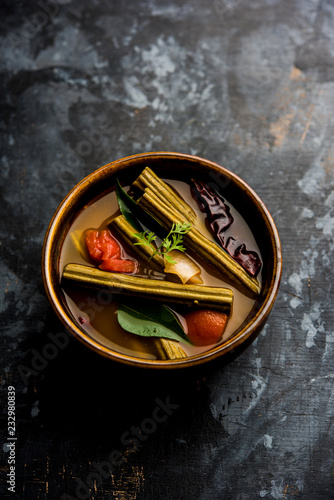 Drumstick Curry or Shevga sheng bhaji or south indian Sambar, served in a bowl over moody background. Selective focus photo