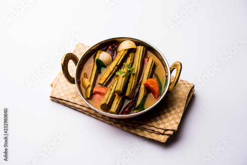 Drumstick Curry or Shevga sheng bhaji or south indian Sambar, served in a bowl over moody background. Selective focus photo