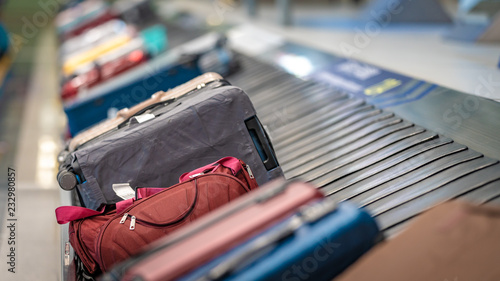 Passengers' Luggage Suitcase Travelling Bags On Conveyor Belt In Airport  photo