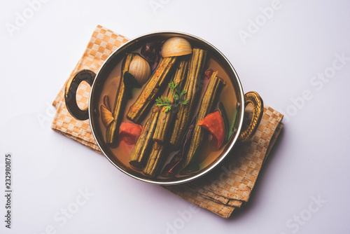 Drumstick Curry or Shevga sheng bhaji or south indian Sambar, served in a bowl over moody background. Selective focus photo