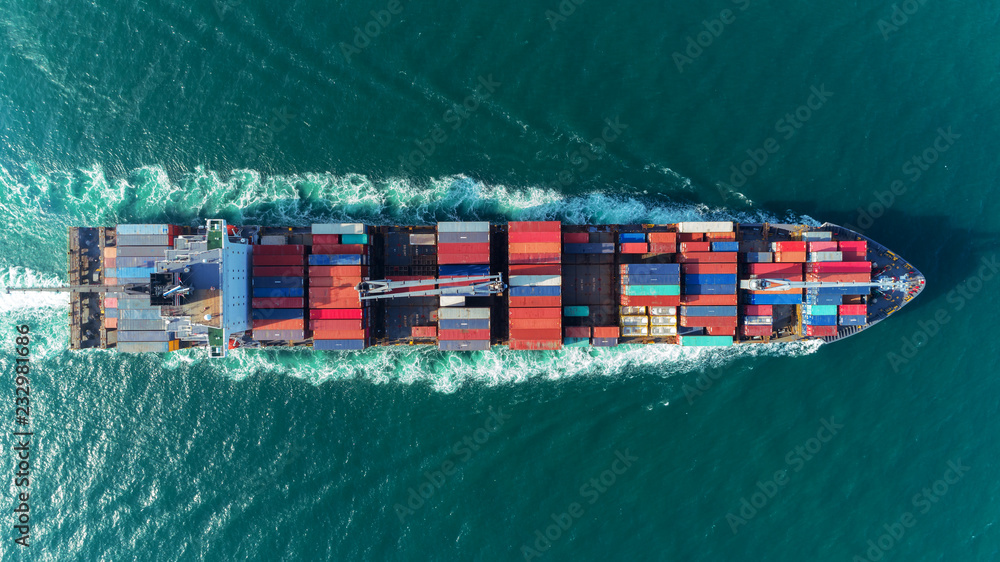 Fototapeta premium Aerial view Top speed with beautiful wave of container ship full load container with crane loading container for logistics import export or transportation concept background.
