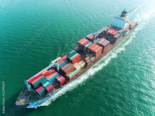 Aerial view container ship full load speed to sea port for logistics import export or transportation concept background.