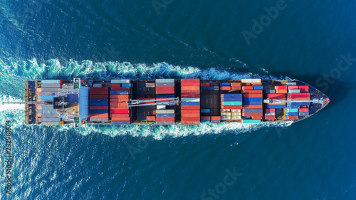 Fototapeta Naklejka Na Ścianę i Meble -  Aerial view Top speed with beautiful wave of container ship full load container with crane loading container for logistics import  export or transportation concept background.