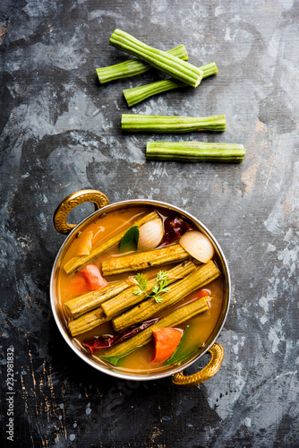 Drumstick Curry or Shevga sheng bhaji or south indian Sambar, served in a bowl over moody background. Selective focus photo