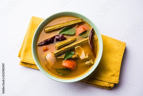 Drumstick Curry or Shevga sheng bhaji or south indian Sambar, served in a bowl over moody background. Selective focus photo