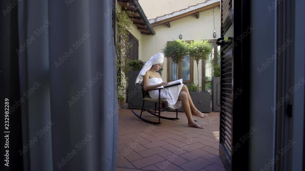 Pretty woman reading magazine by table at home Pretty woman reading magazine by table at home