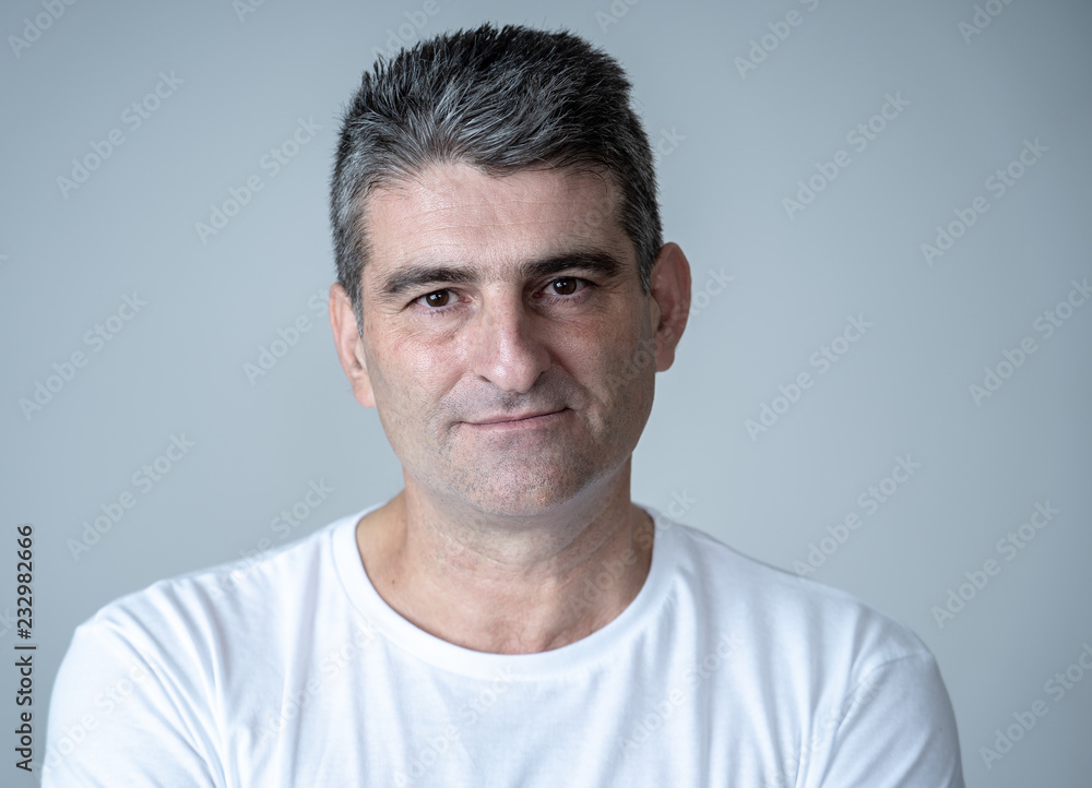 Fototapeta premium Close up portrait of a middle age man in neutral poker facial expressions and human emotions