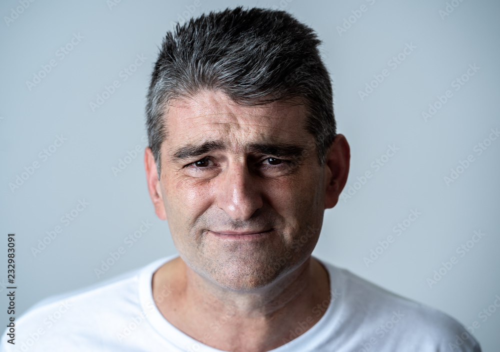 Fototapeta premium Sad and desperate mature handsome man feeling depressed in Facial expressions and depression