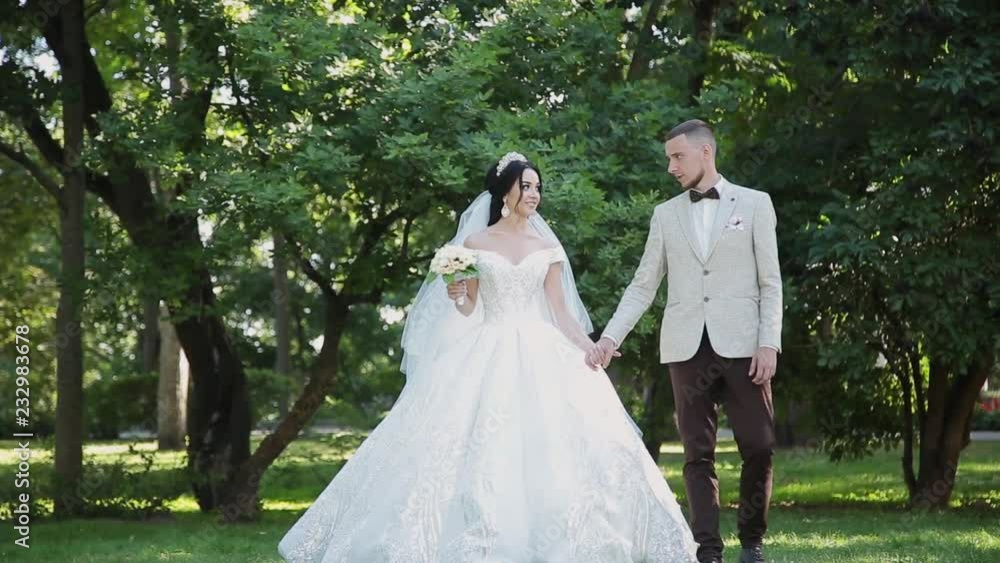 Newlyweds hug and enjoy each other on their wedding day. Newlyweds hug and enjoy each other on their wedding day.