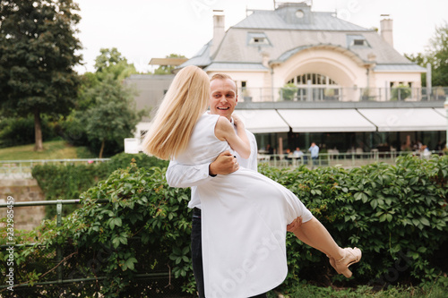 Attrective couple dance on the embanlment. Green background. Active pastime photo