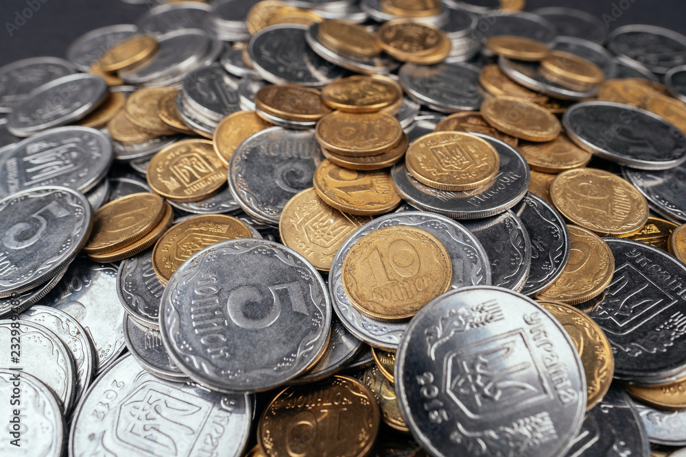 Many coins close up dark background Ukrainian hryvnia Many coins close up dark background Ukrainian hryvnia