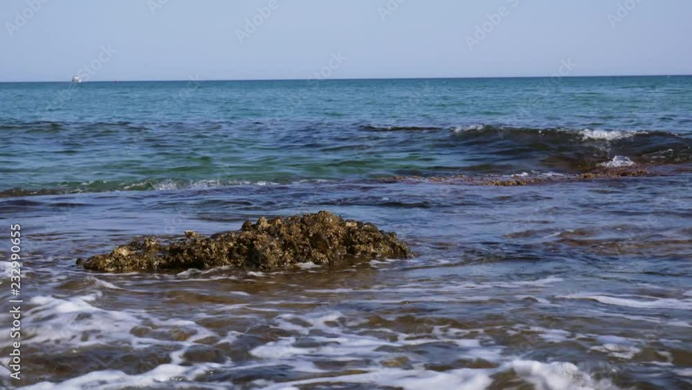 Ocean waves crashing over rocks and foaming Ocean waves crashing over rocks and foaming