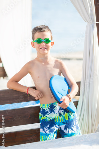Little boy with snorkel by the sea. Cute little kid wearing mask and flippers for diving at sand tropical beach. Ocean coast.