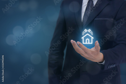 insurance concept, business man hand holding the protection home,construction icon , meaning man, company,business owner try to protect ,save,care and give insurance for customer