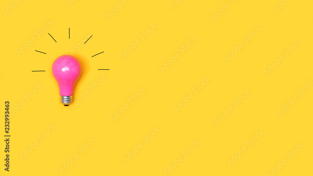 Idea light bulb on a vivid yellow background - obrazy, fototapety, plakaty 
