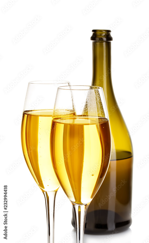 Two glasses of champagne on the background of brown bottles close-up isolated on a white.