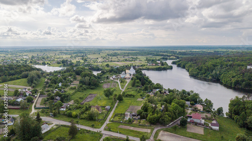 Aerial view of a small river with church © Oleksii Nykonchuk