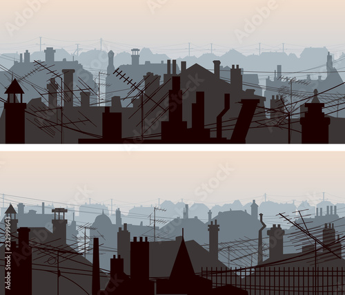 Horizontal banners of downtown roofs with antennas and chimney.