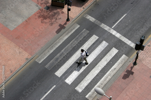 crosswalk with a person, crosswalk on the street, pedestrian crossing in the city