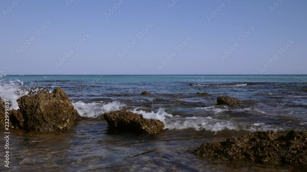 Ocean waves gently lapping over over rocks by the coast of Side in Turkey Ocean waves gently lapping over over rocks by the coast of Side in Turkey
