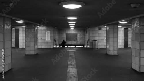 A woman is walking down the stairs in the subway station