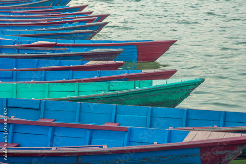 old blue wooden boats on the water. blue red and green boats.