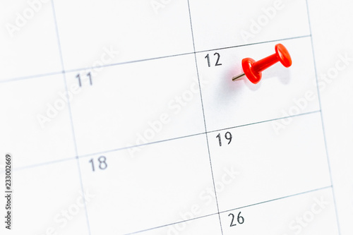 12 date on calendar marked with red thumbtack. Save the Date concept.