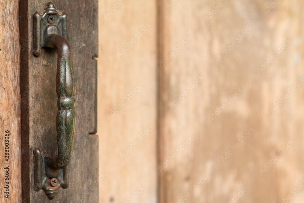 Metal old rusty handle on wooden door