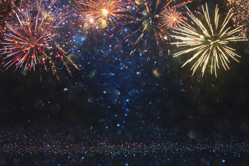 abstract gold, black and blue glitter background with fireworks. christmas eve, 4th of july holiday concept.