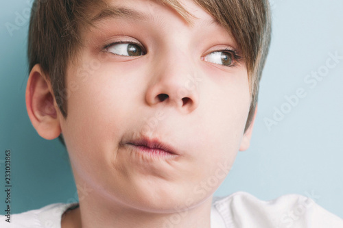Fotografi Surprised boy twisted his mouth in grimace of perplexity
