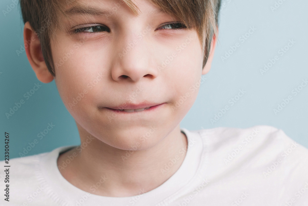 Thoughtful boy with bitter prank bitten his lower lip with his teeth and narrowed his eyes. Thoughtful boy with bitter prank bitten his lower lip with his teeth and narrowed his eyes.