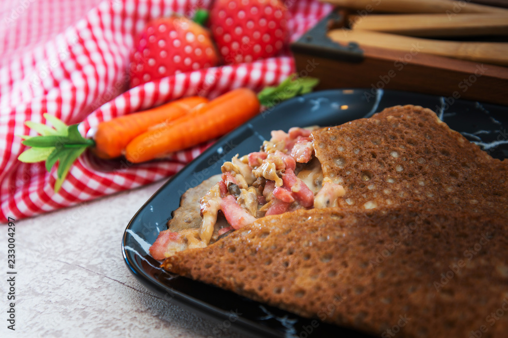 Black wheat and wheat galette topped with cooked ham and emmental cheese Black wheat and wheat galette topped with cooked ham and emmental cheese