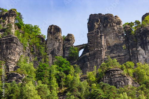View up on stone formations and the famous Bastei bridge in Saxony, Germany